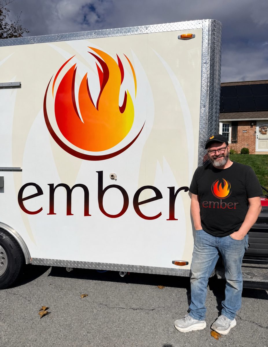 Jason Lewis, founder of TruckTrackr, standing next to his Ember food truck
